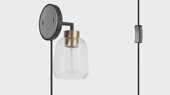 Salma 1-Light Matte Black Plug-In or Hardwire Wall Sconce with Antique Brass Accent Socket and Glass Shade - Globe Electric, 2 of 13, play video