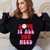 Simply Sage Market Women's Graphic Sweatshirt Love Is All You Need Smiley - 2 of 4