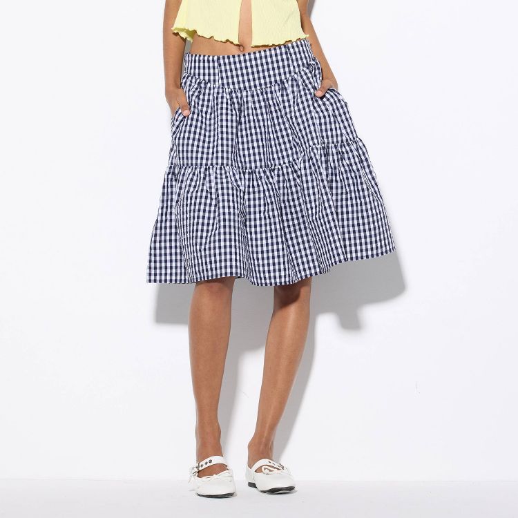 A knee-length skirt with a blue and white checkered pattern and a tiered design.
