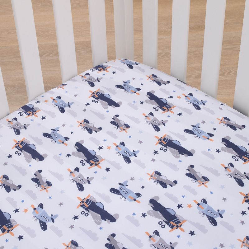 Little Love by NoJo Soar High Little One Navy, Light Blue, Orange, and White Airplanes, Clouds, and Stars Fitted Crib Sheet, 2 of 4
