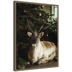 Kate & Laurel All Things Decor Sylvie Framed Canvas Reindeer Sitting Under a Christmas Tree by Michael Schauer - 1 of 4