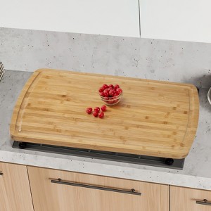 Bamboo cutting board stove cover, 30x20 inches, with adjustable legs and a drain groove, suitable for food cutting. - 1 of 4