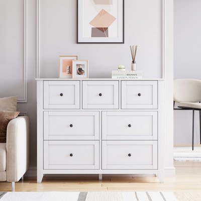 White dresser in a cozy living room with decor on top