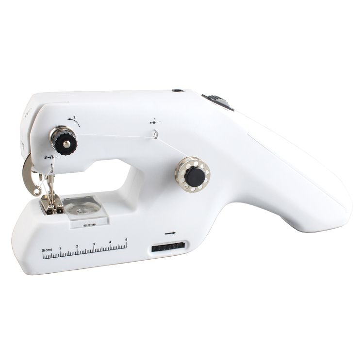 A white handheld sewing machine with visible dials and a ruler marked in centimeters.