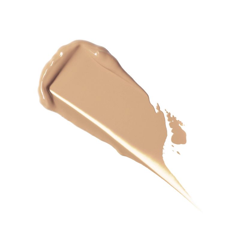 A swatch of beige colored foundation with a smooth texture on a white background.