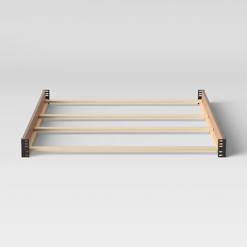 Bed rails for outlet crib conversion