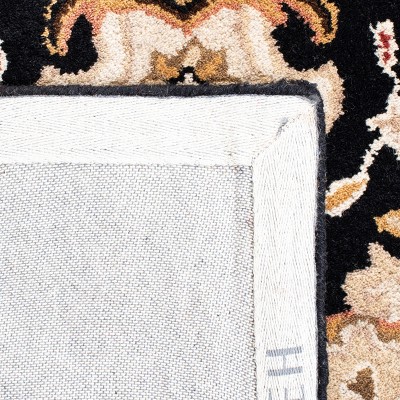 Hand-Tufted Black and Ivory Wool Oval Area Rug