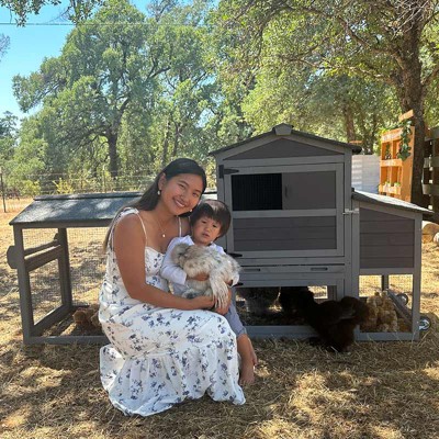 Gray and White Mobile Chicken Coop with Metal Wheels