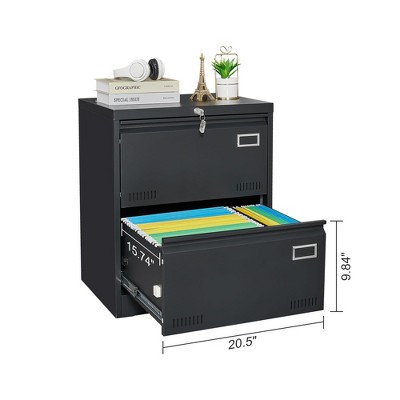 Top of a black metal filing cabinet with drawers, showing contents on top