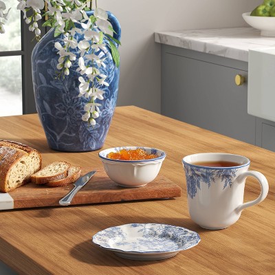 A white colored plate with blue floral patterns placed on a wooden table.