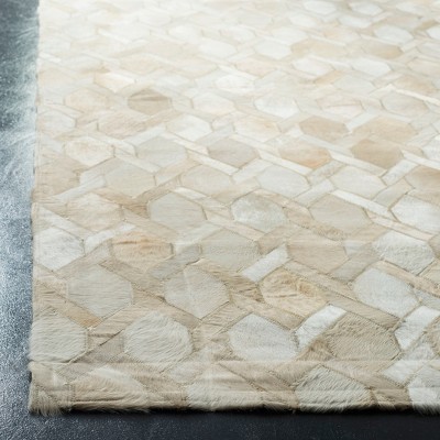 Handmade Ivory Geometric Cowhide 5' x 8' Area Rug