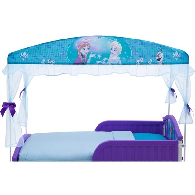 Side view of Frozen canopy bed with canopy frame and curtains