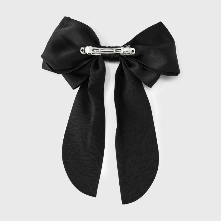 A black colored bow barrette with a silver colored clasp on the back.