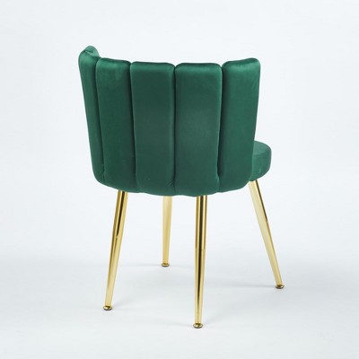 Rear-right angle view of green velvet dining chair with gold legs.