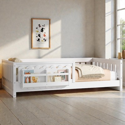 White wooden kids bed with guard rail and decorative paneling