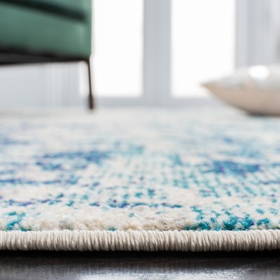 Ivory and Turquoise Abstract 8' x 10' Synthetic Area Rug