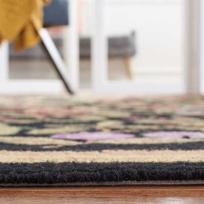 Handmade Black Floral Wool Oval Tufted Rug