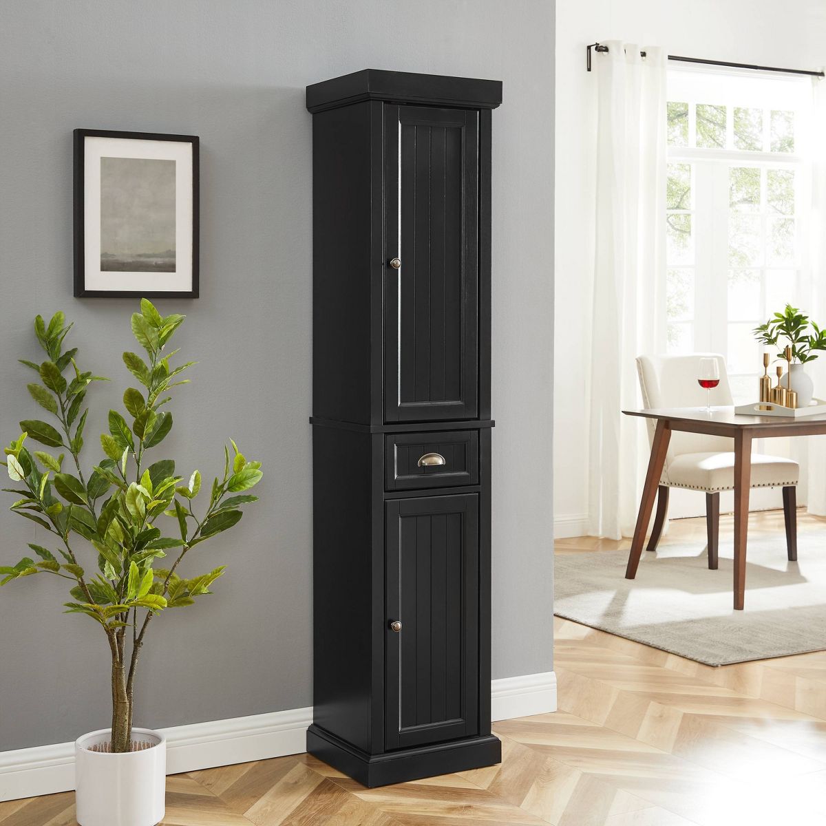 Tall black storage cabinet in a home setting