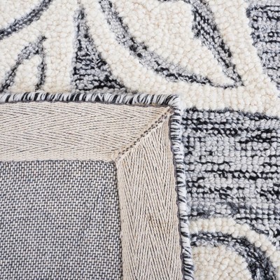Handmade Black and Ivory Floral Wool Area Rug, 5' x 8'