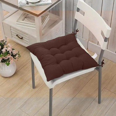 Brown tufted chair cushion pad on a white chair in a different room