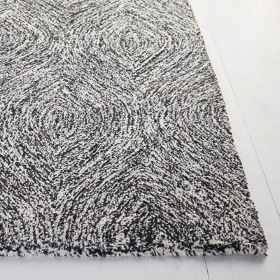 Handmade Black and Ivory Wool Tufted Area Rug, 5' x 8'