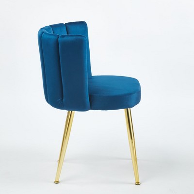 Blue velvet dining chair in profile with gold legs