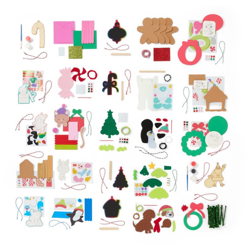 Assorted holiday-themed craft kit components including shapes of trees, gingerbread figures, candy canes, and various colored materials and strings.