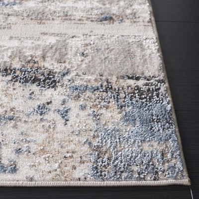 Ivory and Blue Abstract 8' x 10' Synthetic Area Rug