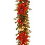National Tree Company Pre-Lit Artificial Christmas Garland, Green, Evergreen, White Lights,Pine Cones, Ornaments, Poinsettia Flowers, Plug In,9 Feet