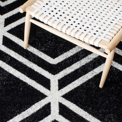 Black and Ivory Geometric 4' x 6' Synthetic Area Rug