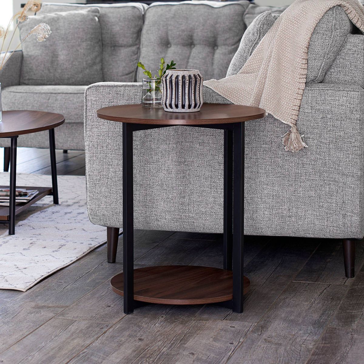 Square-profile round corner end table with dark wood top and lower shelf