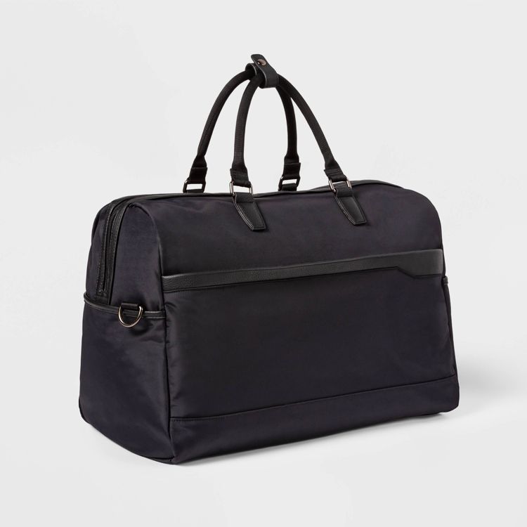 A black colored duffel bag with dual handles and a zippered top.