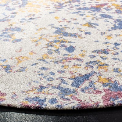 Ivory and Navy Round Tufted Viscose Area Rug
