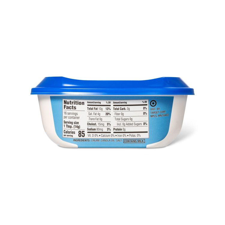 A white and blue container of butter with a nutrition facts label showing 85 calories per serving and ingredients including cream, canola oil, and salt.