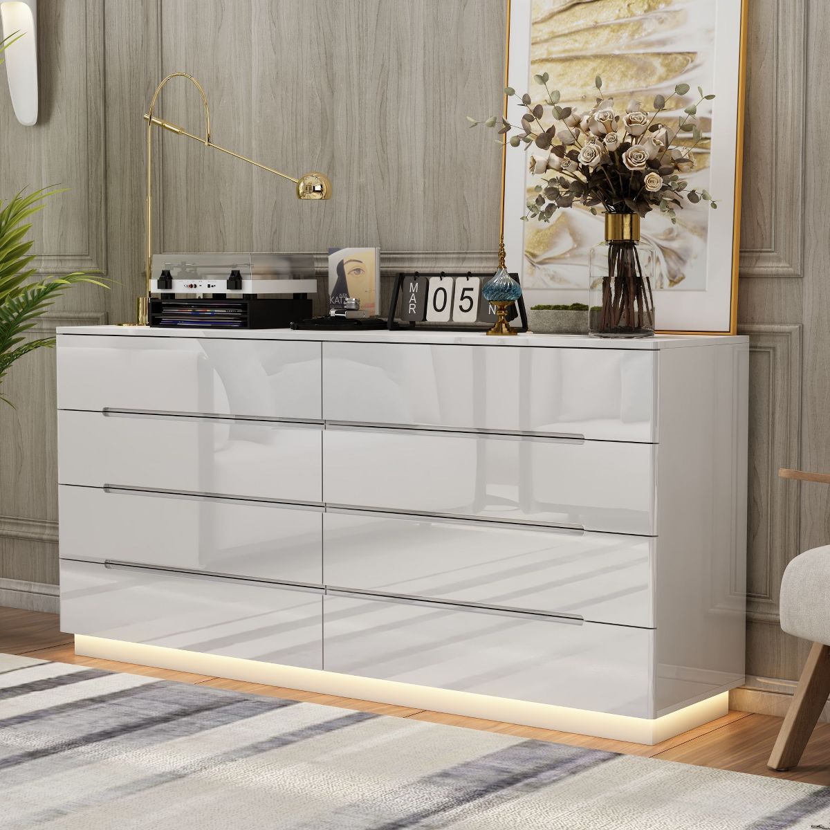 White high-gloss dresser with decor on top and bottom glow