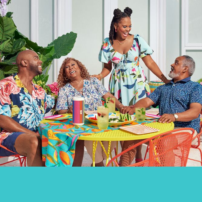 Tab and her family gathered around a table outside, set with dinnerware and grilling items from her collection.