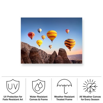 Colorful Hot Air Balloons Over Rocky Landscape Canvas Art