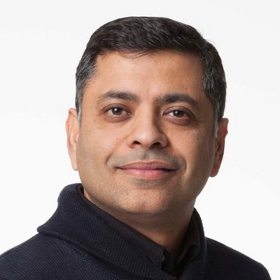 Target Senior Engineering Manager Sandeep Mendiratta smiling wearing a black collared shirt photographed against a white background