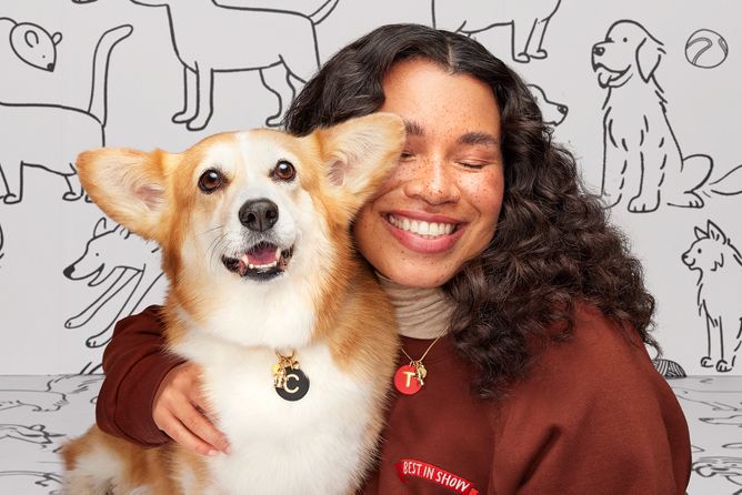 image features a girl and her dog wearing matching charms and a cat with collar featuring tag and charms.