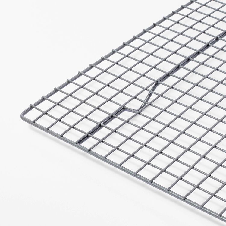 A silver colored wire cooling rack with a grid pattern on a white background.