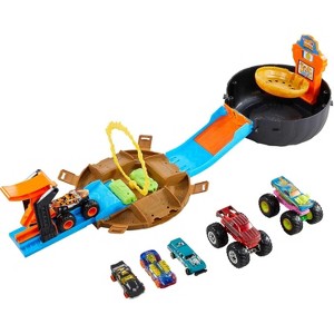 Hot Wheels Monster Trucks Playset - Tire Case Transforms to Race Course with 3 Trucks & 4 Cars - 1 of 4