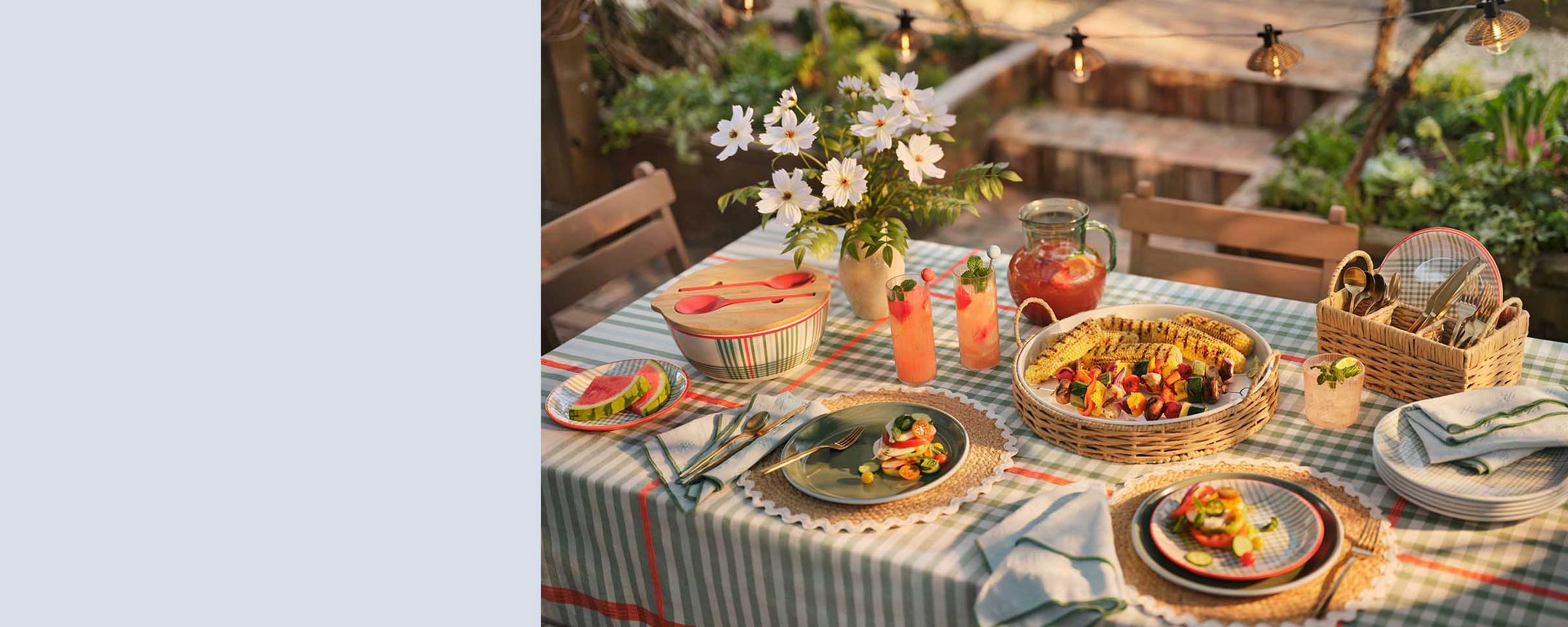 Backyard dining with scalloped, wicker and plaid details.
