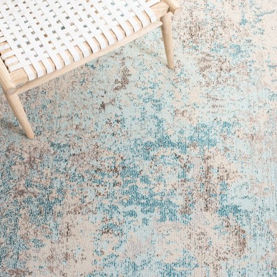 Ivory and Teal 4' x 6' Synthetic Non-Slip Rectangular Rug