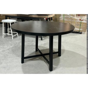 Industrial-style metal round dining table with double-tiered storage shelf and X-shaped metal base, perfect for dining rooms. - 1 of 1