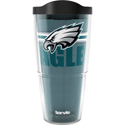 A green Philadelphia Eagles tumbler with a black lid