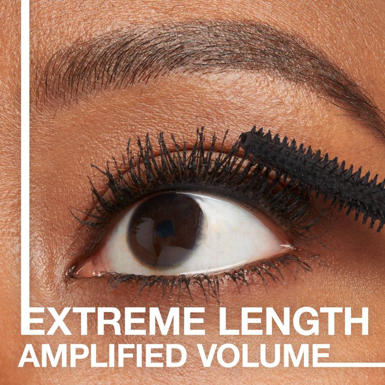A close-up of an eye with black colored mascara being applied to the lashes, accompanied by the text "EXTREME LENGTH AMPLIFIED VOLUME."