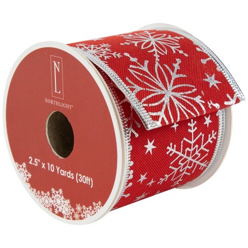 Red curling ribbon with snowflakes on white (2272176)