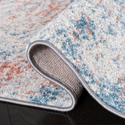 Ivory and Blue Abstract 9' x 12' Stain-Resistant Rug