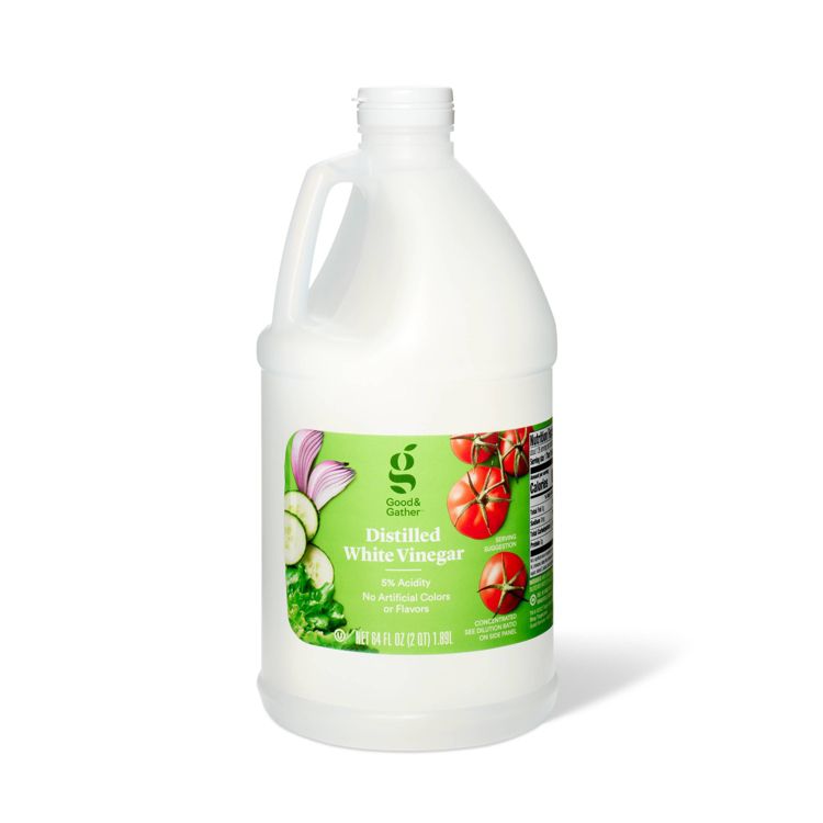 A large white plastic jug of Good & Gather Distilled White Vinegar with a green label showing tomatoes, cucumbers, and onions, labeled as 64 fl oz (2 qt) 1.89 L with 5% acidity.
