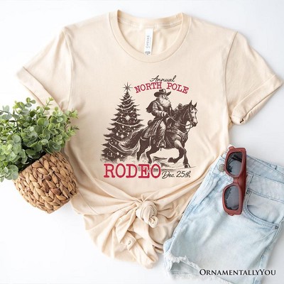 Annual North Pole Rodeo T-Shirt, Funny Cowboy Santa Christmas Tee for Country Lovers| OrnamentallyYou